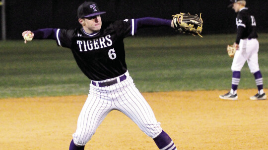 Hayden Heselmeyer fields a ground ball before throwing the runner out at first base.