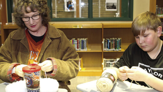 Jovin Maybin (right) and Taylor High School librarian Renee De Hoyos begin new crochet projects at the weekly meeting of the Taylor Middle School Crochet Club.