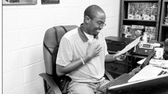 Area Editor Jason Hennington smiles as he reads congratulations wishes from his co-workers on his 10th year anniversary at the Taylor Press. Photo by Grace Horvath