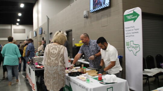 District 4 Councilman Robert Garcia (left) and Jesus Lopez serve chicken and shrimp rolls to hungry attendees at the Williamson County Expo Center as part of the ‘Food Dudes’ fundraiser for local teachers’ initiatives. Photos by Nicole Lessin