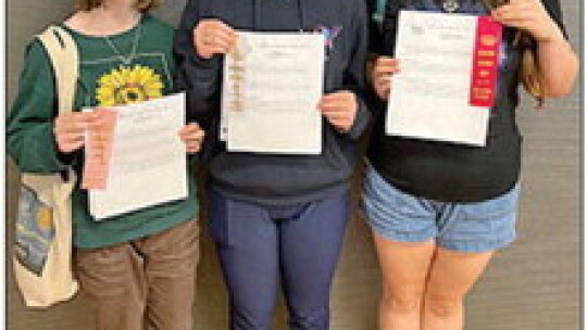 St. Mary’s eighth graders Sofia Jessup, Demitria Dahlberg and Dulcie Krogmann show off their PSIA ribbons.