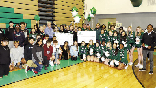 Taylor Middle School coach Kale McQuillen is awarded a check for $2,456 to fund archery supplies for the school’s outdoor recreation program. Photo by Tim Crow