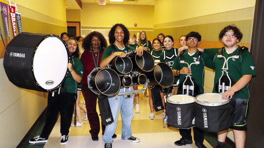 The Taylor High School drum line and cheerleaders take a break from leading the Mallard Mania parade at THS. They are joined by staff member, Bobbie Griffin.