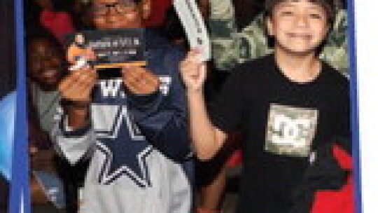 Jeremiah Rojas, Elliot Biltoft and Malik Robertson eagerly display their tickets to hear a presentation from former NASA astronaut, Jose Hernandez.