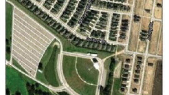 This aerial view shows the BCA parking lot and stage with nearby surrounding residences. The neighborhood is still expanding, with more homes and apartments being built nearby. Source: MapQuest.