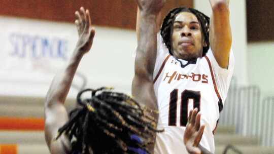 Dylon Richardson jumping up towards the basket before throwing down a dunk.