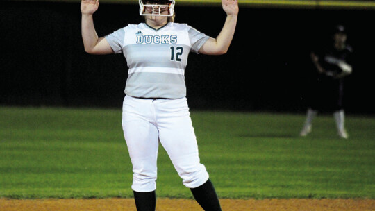 Lady Ducks sophomore Maci Kennick celebrating with her teammates after landing on second base.