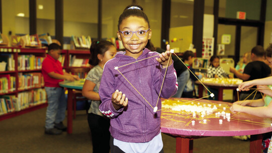 Mya Green displays the structure she built during the engineering presentation at her school’s Career Day.