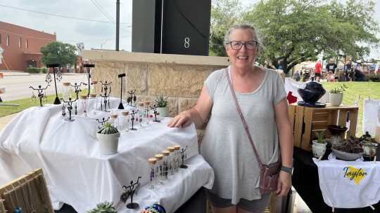 Owner of Nash McKinnon designs, Juliana Woodall stands next to her booth of handmade jewelry, pottery, stained glass and butter at the Taylor Farmer’s Market Saturday, May 6 at Heritage Square, 400 N. Main St.