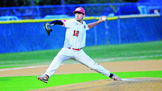 Ben Jamieson stepping towards the batter to throw a strike for a strikeout.