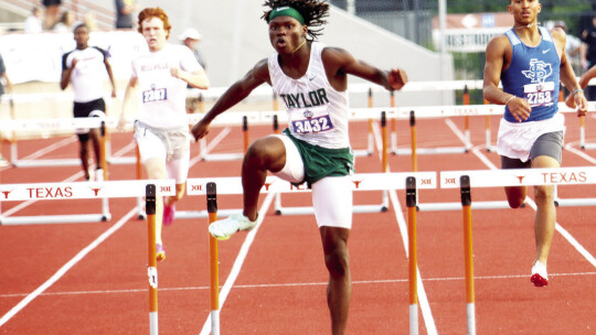 Jarvis Anderson crosses the finishing line in first place in the boys’ 300meter hurdles final. Photo by Briley Mitchell