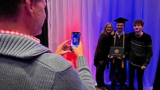 Families celebrate with photos after graduation at Kalahari Resorts and Conventions in Round Rock. 