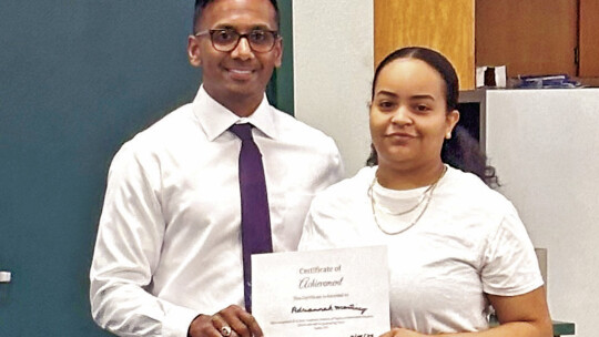 Taylor Superitendent Devin Padavil (left) presents Adriannah Martinez with a certificate of completion for finishing the final semester at TASC.