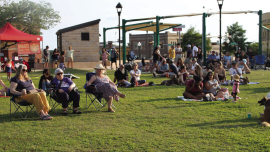 Hundreds of people showed up with lawn chairs to hear the first Music on Main concert for the spring series. Photo by Nicole Lessin