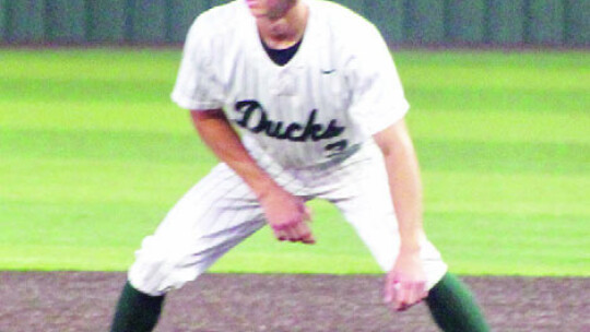 Taylor varsity baseball senior outfielder Jake Jansky takes a lead from first base on May 25 during the Ducks’ 4-2 victory in Game 1 of the regional semifinals vs. Spring Hill. Infielders from the Taylor High School varsity baseball team gather together on Thursday, May 25 during the