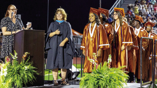 Hutto seniors prepare to walk the stage and receive their diplomas at graduation.