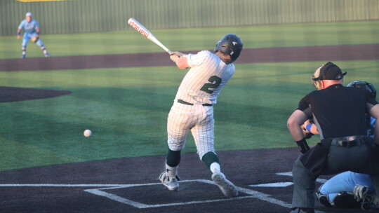 Taylor sophomore catcher Nick Treuter makes contact and puts a ball in play during the Ducks’ 4-2 victory on Thursday over Spring Hill. 