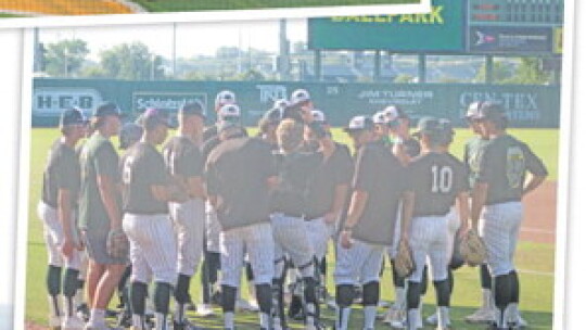 RIGHT: Ducks baseball players gather around during pregame warmups on May 31, prior to the start of Game 1 of the regional finals vs. China Spring.