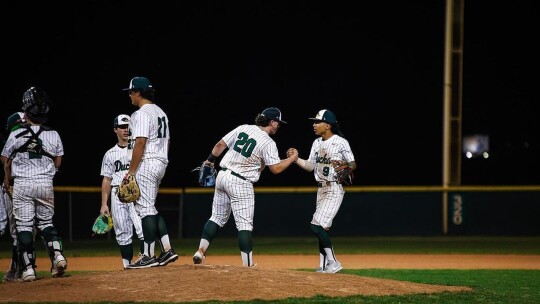 Ducks varsity baseball senior Cohen Tyree (20) and sophomore Mario Aguero (9) celebrate together during Taylor’s 7-2 home victory against Navarro. 