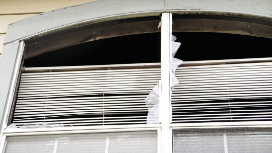 The charred window frame of an upstairs unit at the Burnett Place Apartments gives an idea of the intensity of the blaze, which officials believe started in a kitchen Monday. Photo by Nicole Lessin