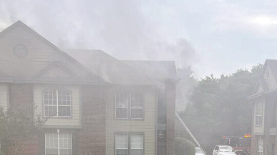 The lower floor of Building 3 sustained extensive water damage during a fire at the Burnett Place Apartments on June 5. Firefighters using a ladder rescued two residents and no injuries were reported. Courtesy photo