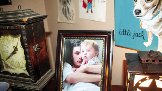 Photos and other mementos of Hunter Crump, including a portrait of the young man holding his nephew, are displayed around the family’s Coupland home. Crump died after taking a counterfeit pain pill laced with the synthetic opioid fentanyl. Photo by Nicole Lessin