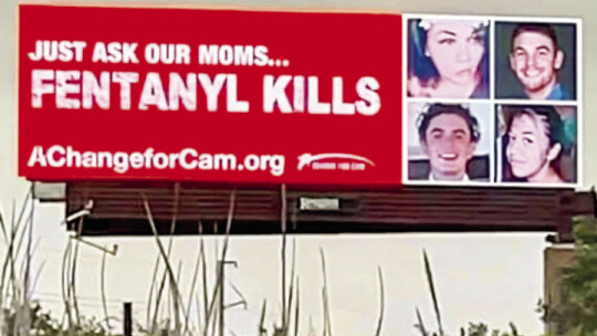 A billboard on Interstate 35 in Kyle bears Hunter Crump’s face, alongside other young people poisoned by fentanyl. Photo by Nicole Lessin Courtesy photo