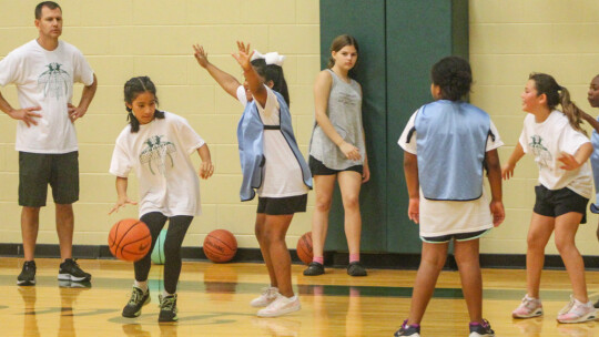 Jay Reed coaches up a scrimmage between younger kids on June 8 during the Lady Ducks Youth Basketball Camp. Photo by Andrew Salmi