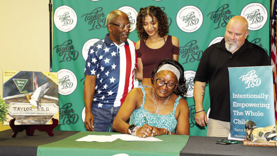 Long time Taylor High School paraprofessional, Eliza Ackerman, signs to elevate her career to a teaching position with Taylor ISD next year.