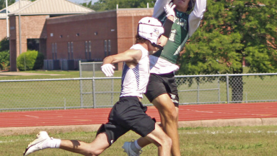 Ducks varsity football senior wide receiver Jordan Pickerill leaps up to make a catch over a Lago Vista High School defender during the 7-on-7 state qualifying tournament held in Cameron.