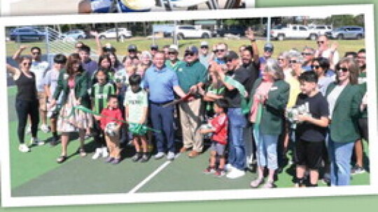 ABOVE: Parks and Recreation Director Tyler Bybee talks to guests about he new soccer mini-pitch in Murphy Park. LEFT: A ribbon cutting was held in Murphy Park for the new soccer mini-pitch located near the basketball courts in the park.