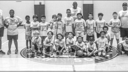 Ducks second through fifth graders gather around for a photo at the Taylor High School small gym on June 15 at the conclusion of the Boys Summer Basketball Camp. Photo by Andrew Salmi