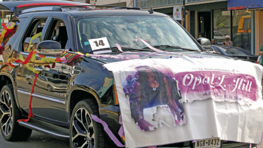 Johnathan Sawyer honors his late mother Opal L. Hill during the Juneteenth parade. Photo by Jason Hennington