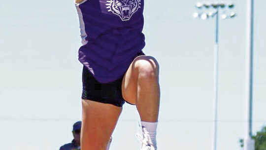 Tigerettes varsity track and field junior Melaina Grissom soars through the air in the triple jump event on April 28 during the 2A Region 4 meet held at Javelina Stadium in Kingsville. Photo by Bethany Grissom