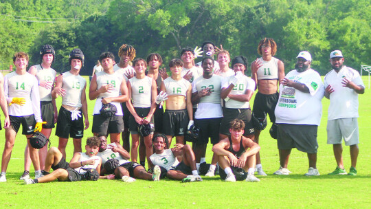 Taylor High School varsity football players and coaches proudly pose for a photo on Thursday, June 22 after defeating Jasper High School 41-26 at Veterans Park and Athletic Complex in College Station.