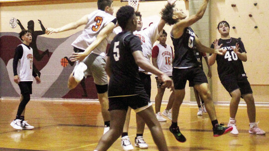 Ducks boys varsity basketball senior Antonio Torres drives hard into the paint and scores an acrobatic layup on June 26 during a Taylor summer league scrimmage against Smithville High School in Bastrop.