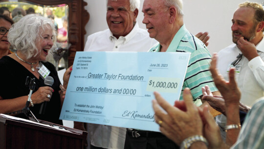 Ed Komandosky presents $1,000,000 donation check to Greater Taylor Foundation Board Chair Diana Phillips. Photo by Hunter Dworaczyk