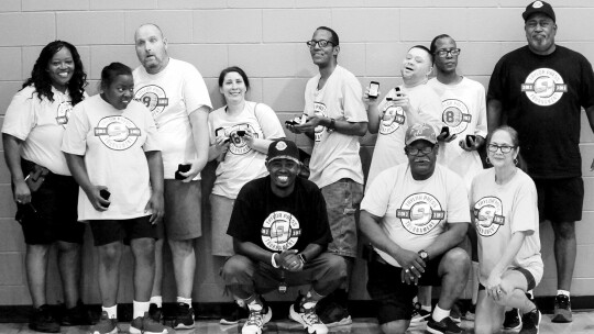 The Shining Stars team, the special needs group, poses for a photo on July 10, 2022, with Taylor Press area editor Jason Hennington.