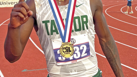 Ducks star Jarvis Anderson proudly shows off his gold medal after winning the 300-meter hurdles event on May 11 at the UIL Track and Field Championships held at Mike A. Myers Stadium in Austin. Photo by Briley Mitchell