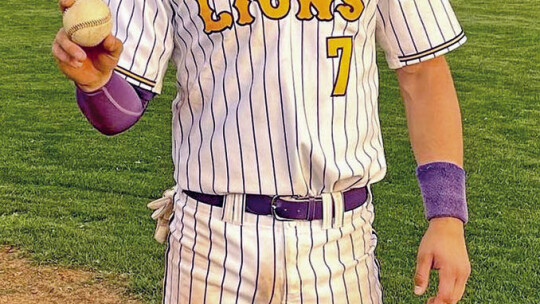 Granger High School varsity baseball alumnus Nathan Tucker proudly poses with a ball on April 25 following a thrilling 10-11 victory at home vs. Holland High School. Tucker hit a walk-off home run in the bottom of the seventh inning to give the Lions the win on Senior Night. Photo courtesy...