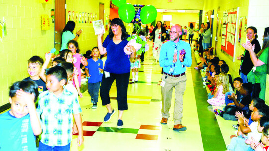 T.H. Johnson Elementary students and staff celebrate their Teacher of the Year, Lucia Arellano, with a parade around the campus in April. Photo by Tim Crow