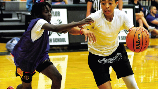 Markell Fitzgerald (right) drives past a defender to the basket 10th annual Taylor Press 3-on-3 Basketball Tournament last weekend. Photo by Larry Pelchat