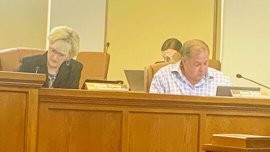 Russ Boles, the commissioner that represents Taylor’s precinct, sits with Commissioner Valerie Covey. Both voted in favor of the salary increases. Photo by Hunter Dworaczyk.