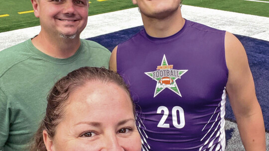 Ducks varsity football senior linebacker Jaden Rush happily poses with father Joe Rush and mother Ashley Rush on July 16 during the Junior Day Football National Showcase held at AT&amp;T Stadium in Arlington.