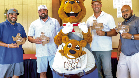 The members of Kanga Roof pose with the company’s mascot and their second place trophies.