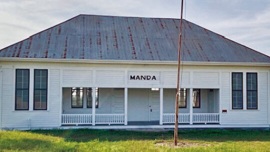 Built in 1915, the Manda School, a landmark in the New Sweden area, is the only two room schoolhouse still standing and used by the public in Travis County, serving the rural area around New Sweden as a community center. The organization Friends of Manda School maintains the historic struc...