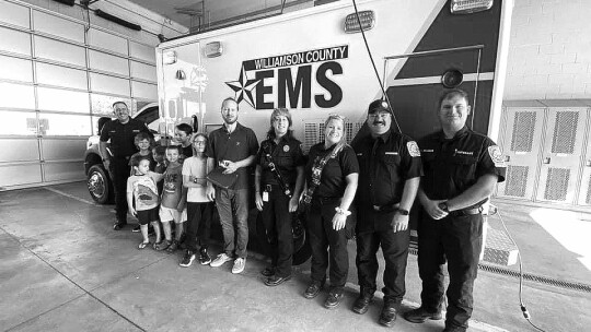 (Front) Lucas, Elia and Mateo were honored by Daniel Baum, Taylor fire chief, and firefighters for their quick thinking to help their father.