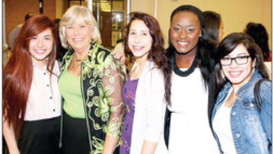 Leschber, who taught career and technical education classes, poses with students during the 2015 Community Appreciation Banquet.