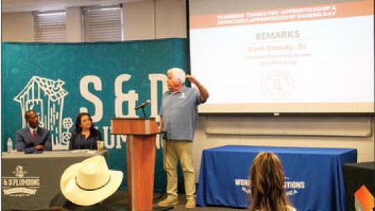 Sam Dowdy Sr., owner and operator of S&amp;D Plumbing, tells the audience what the word “Craftsman” means to him during the signing day event.