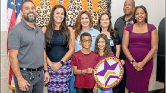 Hutto Elementary School campus liaison, staff and students celebrate winning the Purple Star Award. Photo courtesy of HISD